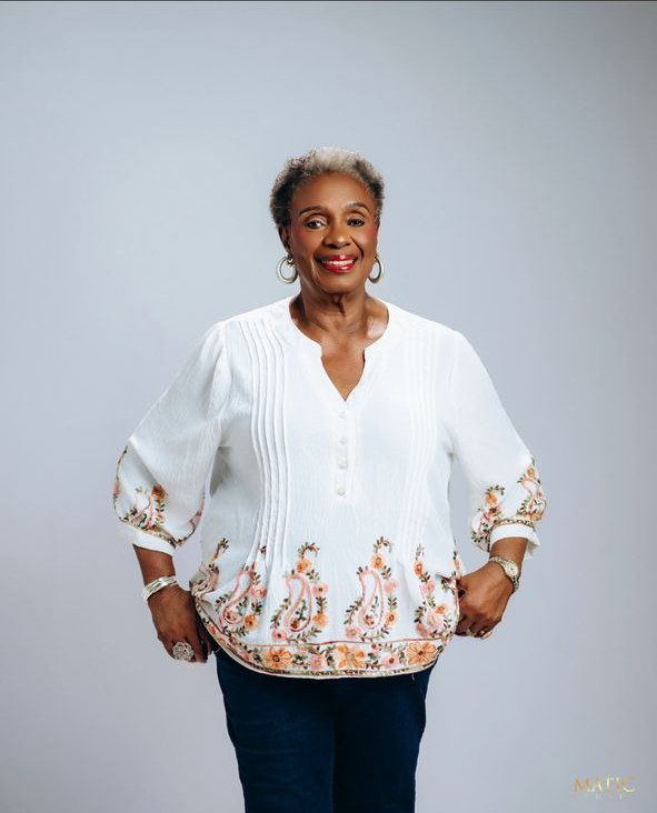Chief Mrs. Josephine Chinyelu Nwosu smiling in a white embroidered blouse.