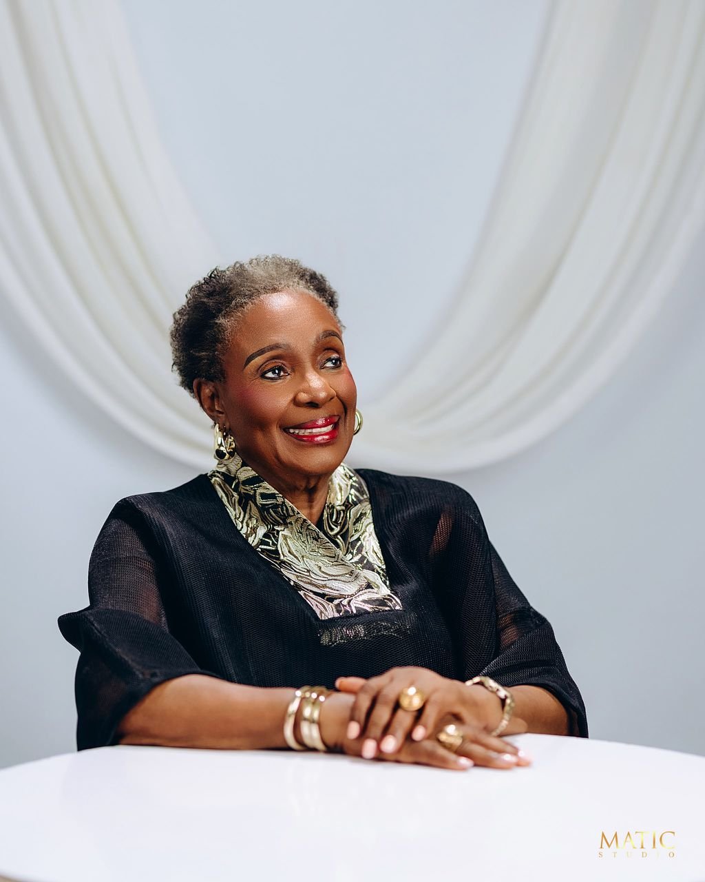 Close portrait of Chief Mrs. Josephine Chinyelu Nwosu seated in a black outfit.